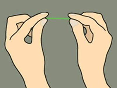 Two hands holding a dental floss string between them against a gray background.
